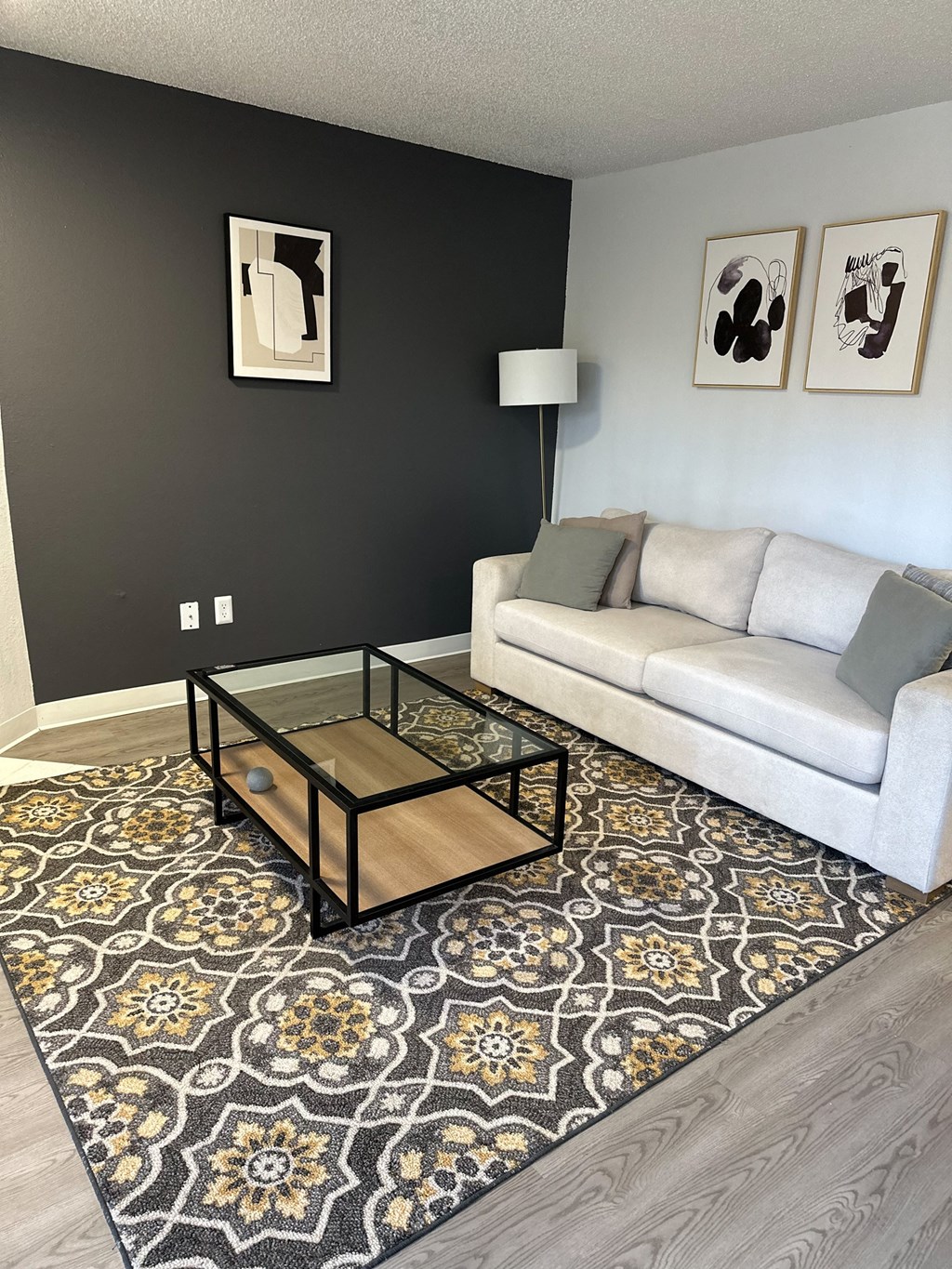 A living room with a white couch and a coffee table.