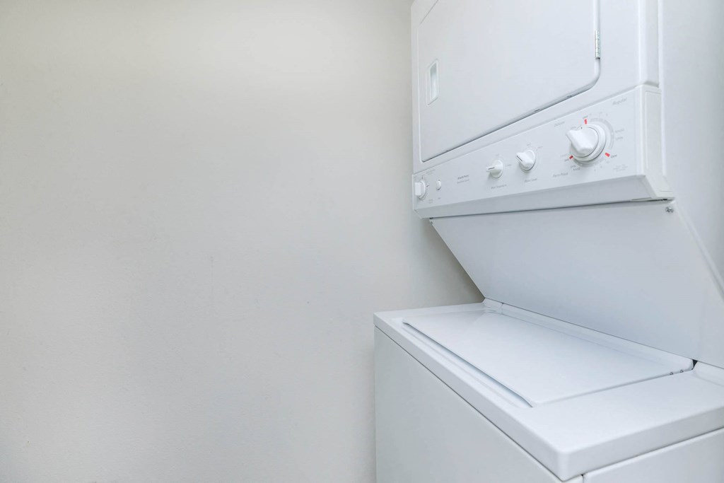 a washer and dryer in a room with a white wall  at Delano, Washington