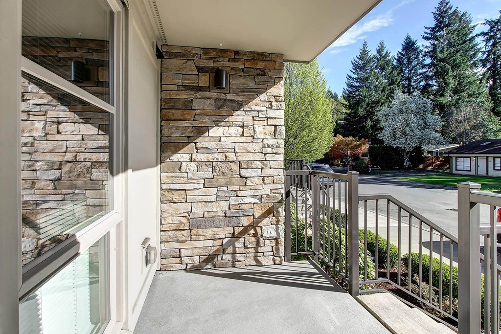 a balcony with a view of a street and trees at Delano, Washington