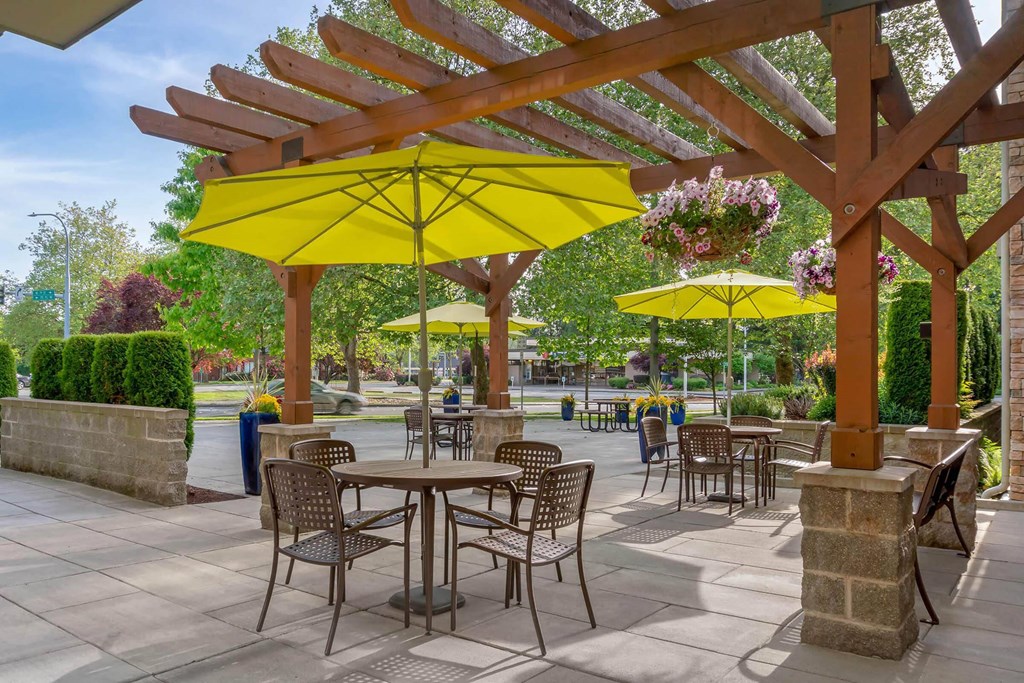 a patio with tables and chairs and umbrellas at Delano, Redmond