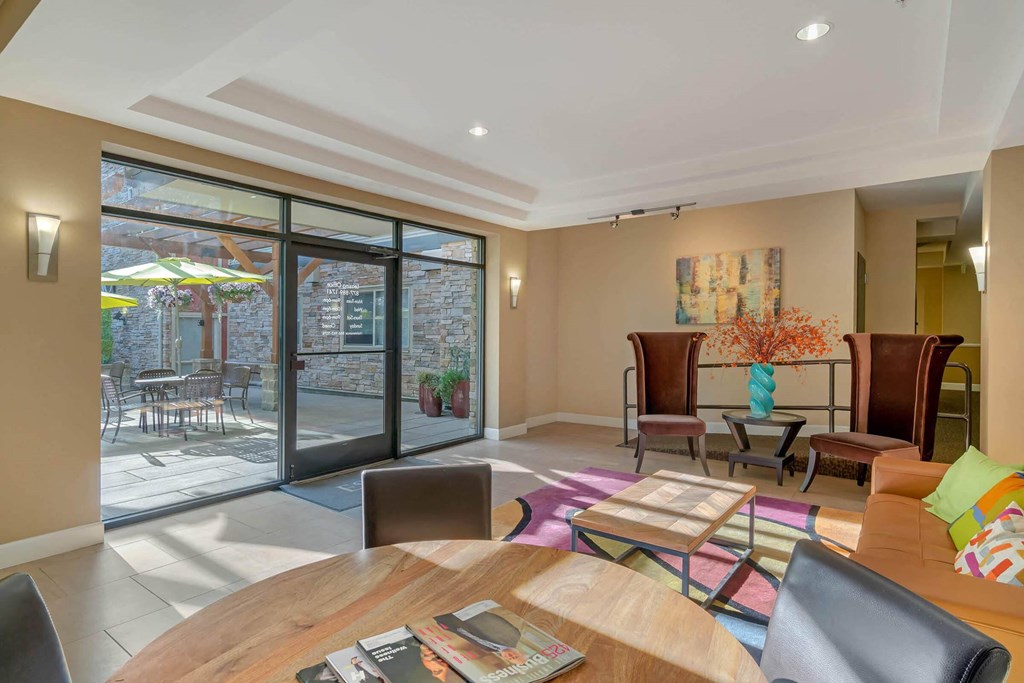 a living room with a round wooden table and a patio  at Delano, Redmond Washington