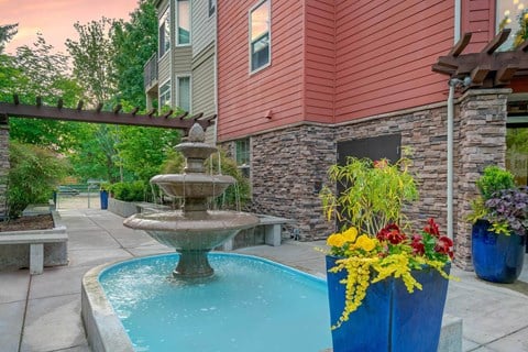 a fountain in front of a house with a swimming pool at Delano, Redmond, WA
