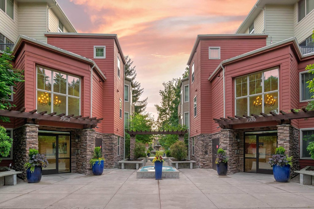 the courtyard of a condo building with a patio and potted plants at Delano, Redmond Washington