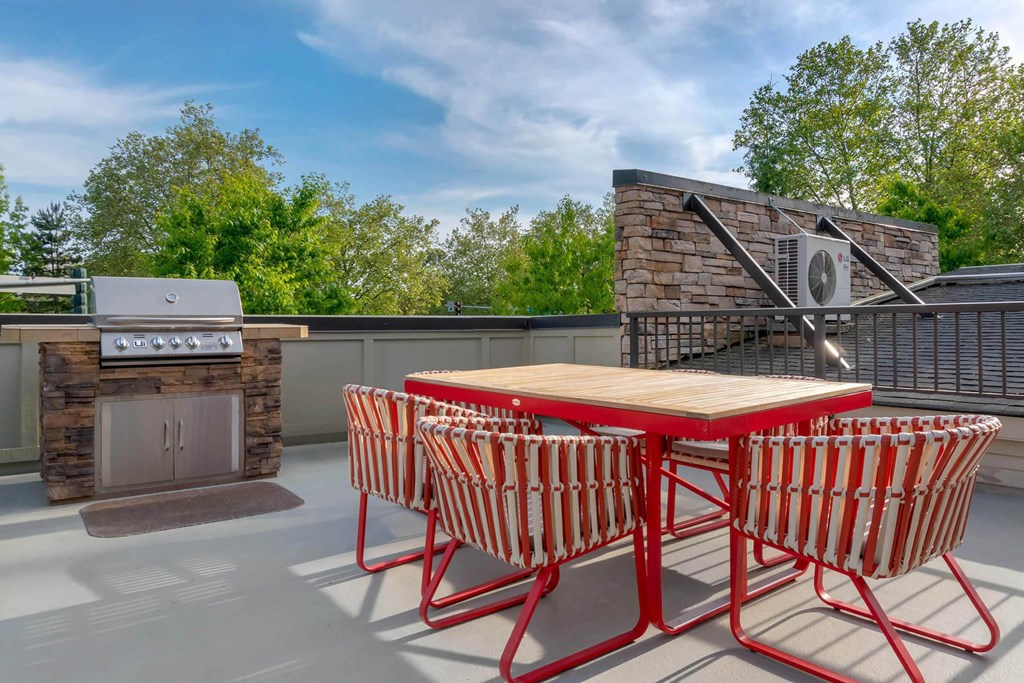 a patio with a table and chairs and a grill at Delano, Redmond Washington