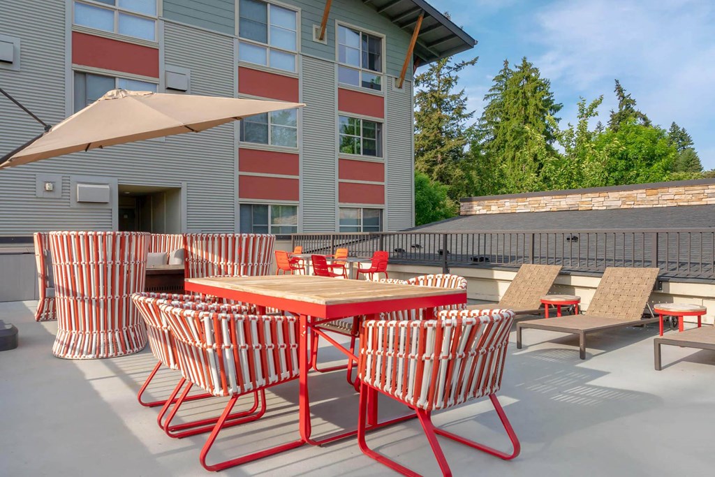 a patio with tables and chairs and a building in the background  at Delano, Washington