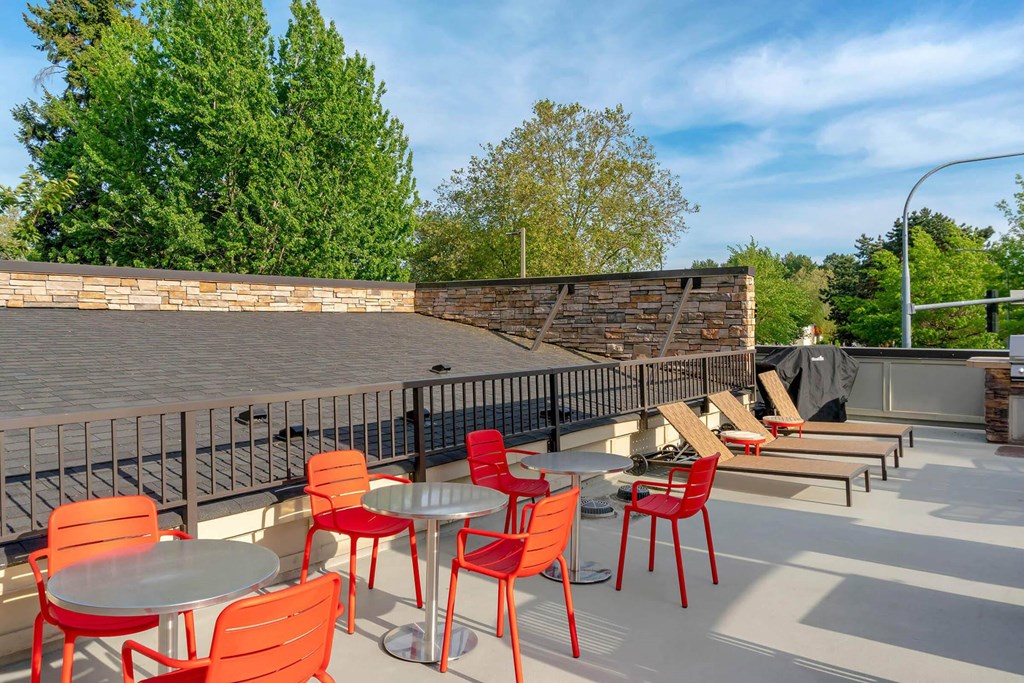 a patio with tables and chairs and a brick wall at Delano, Washington, 98052