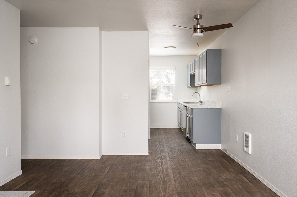 Living room with a wooden floor and a ceiling fan at Kentwood Apartments, Washington