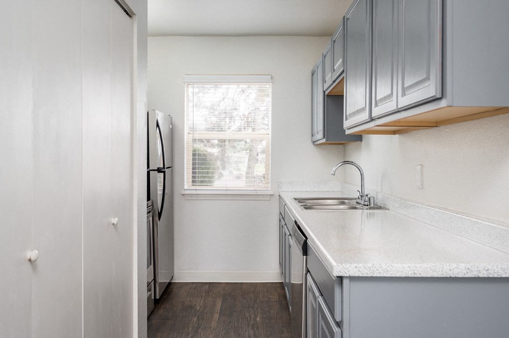 Granite Counter Tops In Kitchen with windows at Kentwood Apartments, Kent, WA