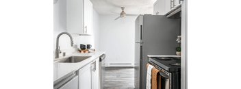 A modern kitchen with a stainless steel refrigerator and a stove top oven.