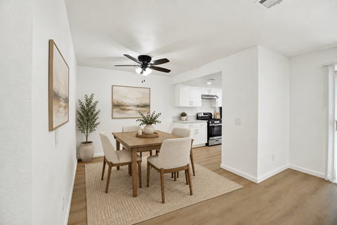 Dining area with wood table and ceiling fan at Coventry Square Apartments, California