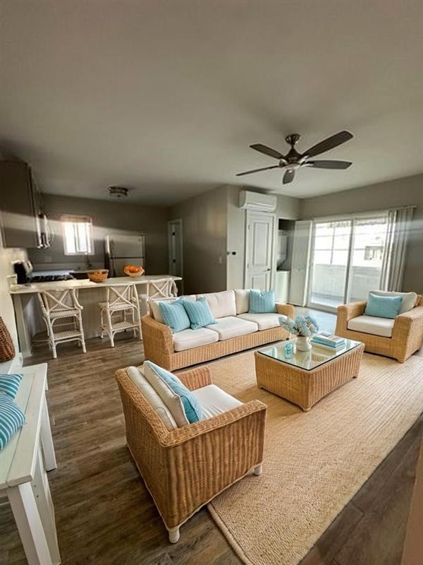 A living room with a white couch and a brown wicker chair.
