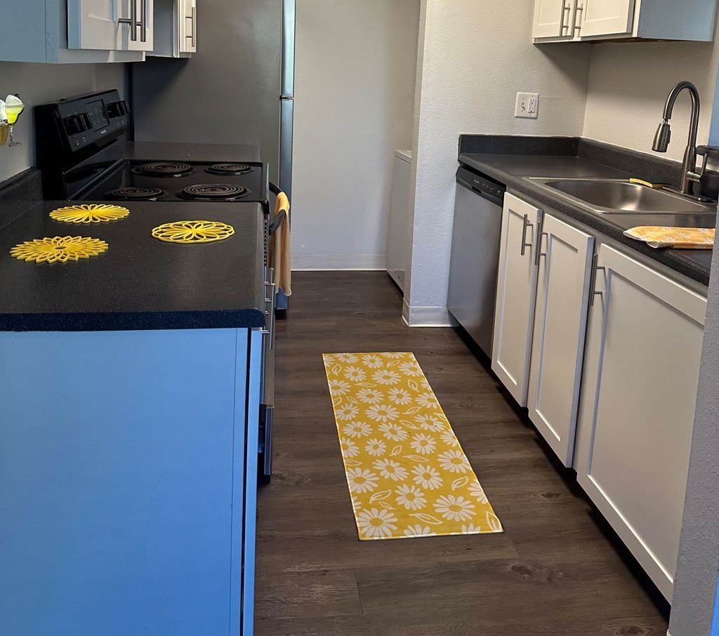 Kitchen with a black countertop at Capri Apartments, Washington
