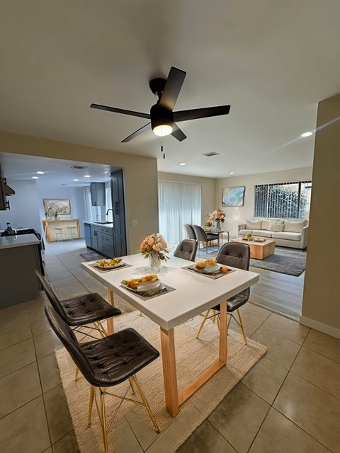A dining room with a table set for four.