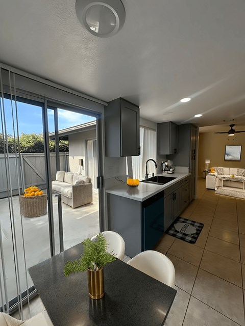A modern kitchen with a dining table and chairs.