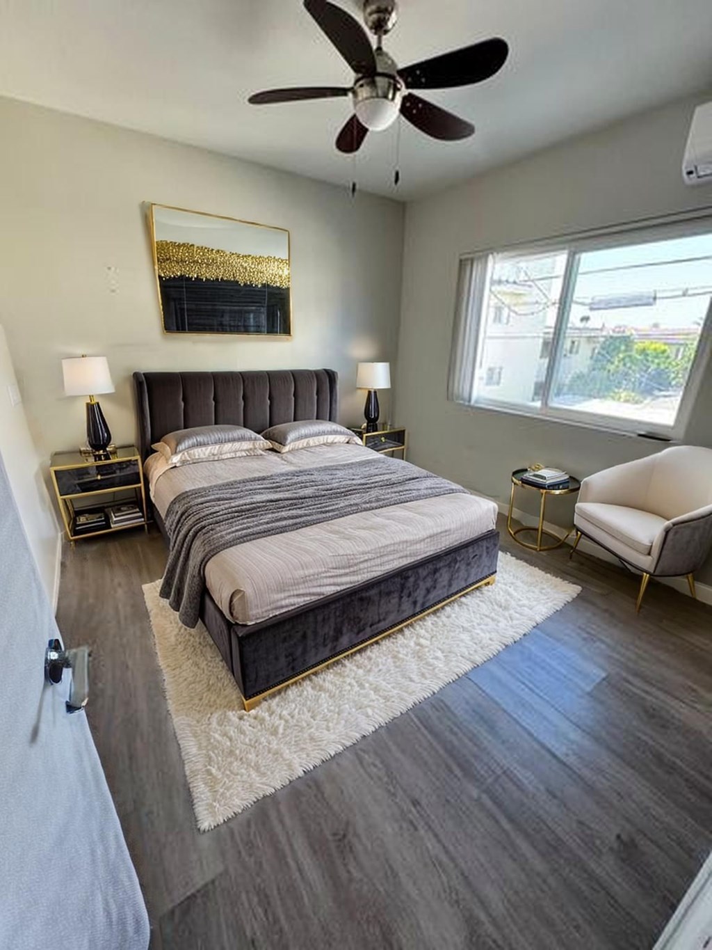 A bedroom with a large bed and a ceiling fan.