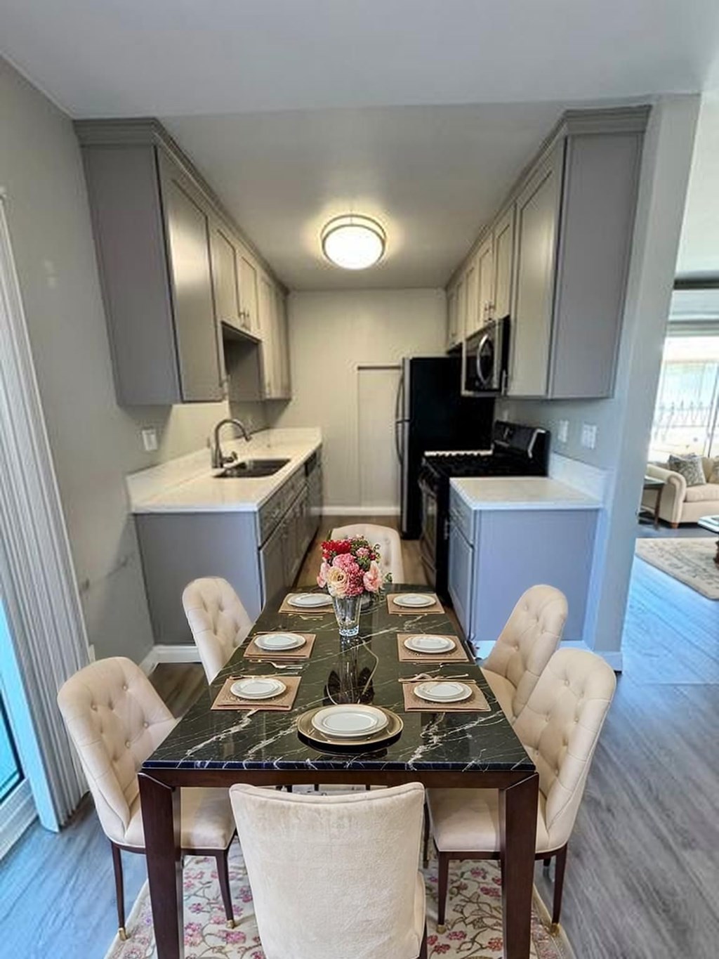 A kitchen with a table set for a meal.
