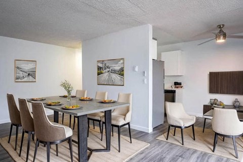 A dining room with a table set for six.