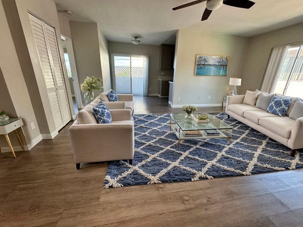 A living room with a sofa, two chairs, and a coffee table.