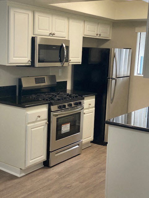 a kitchen with a stove and a refrigerator