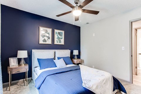 A bedroom with a bed, nightstands, and a ceiling fan.at Laurel, Union City, GA  