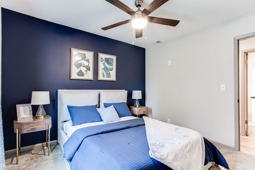 A bedroom with a bed, nightstands, and a ceiling fan. A bedroom with a bed, nightstands, and a ceiling fan.at Laurel, Union City, GA