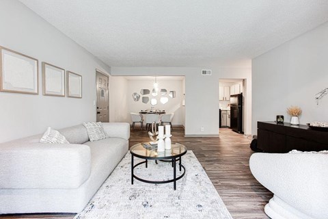 A living room with a white couch and a coffee table.