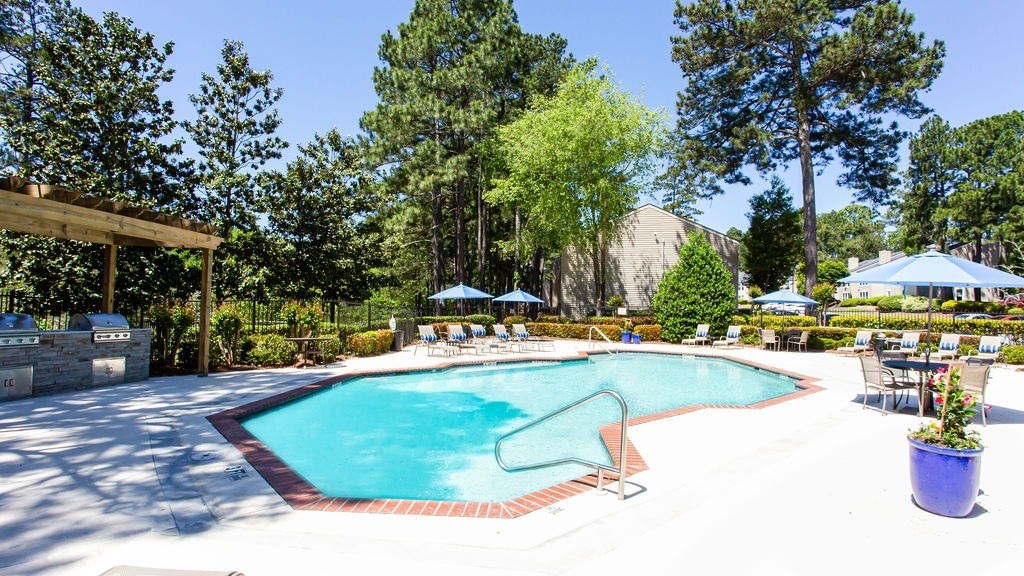 A pool surrounded by trees and chairs. A pool surrounded by trees and chairs.at Laurel, Union City, GA 30291