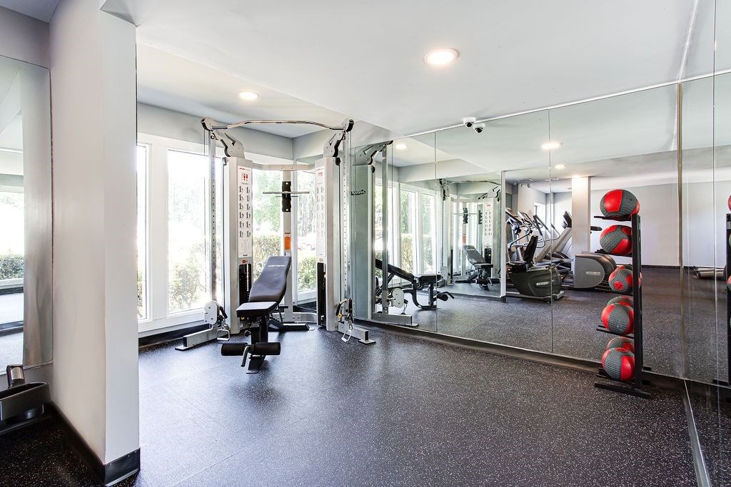 A gym with a row of red dumbbells on the right. A gym with a row of red dumbbells on the right.at Laurel, Georgia, 30291