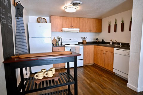 A kitchen with wooden cabinets and a white refrigerator.