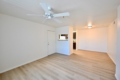 A room with a ceiling fan and light fixture.