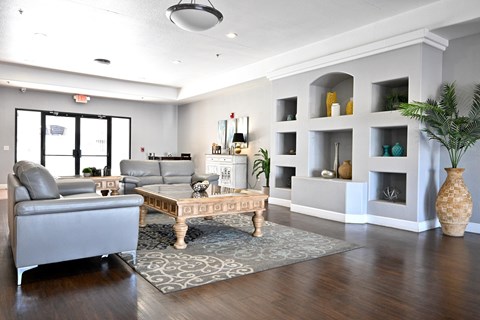 A living room with a grey couch and a coffee table.