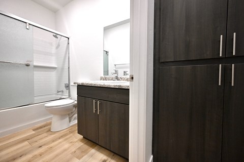 A bathroom with a toilet, sink, and shower.