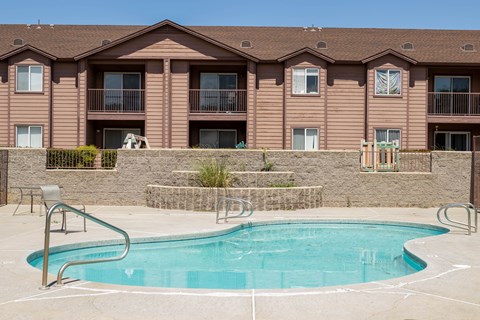 a swimming pool with a building in the background