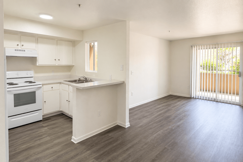 A kitchen with white appliances and cabinets.