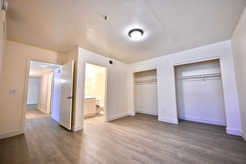 A spacious room with a doorway leading to another room.