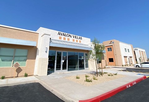 Avalon Villas is a building with a red and white striped awning.