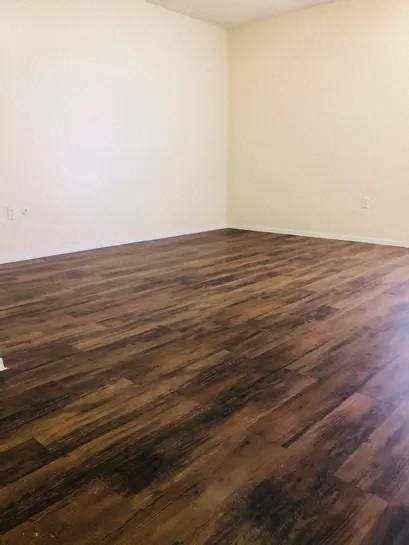 a room with a wooden floor and white walls