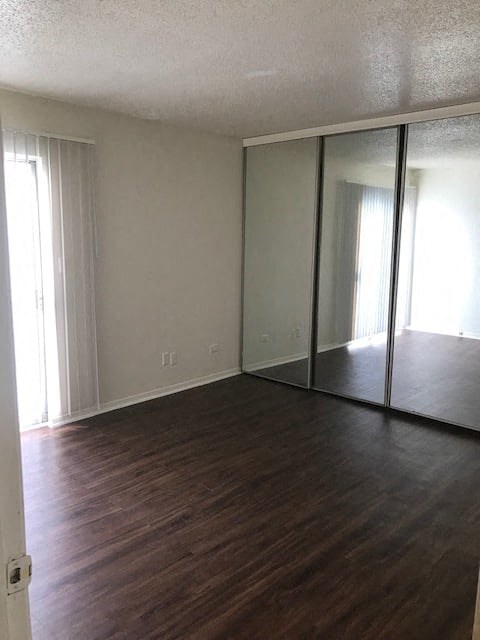 a room with a wooden floor and a large mirror
