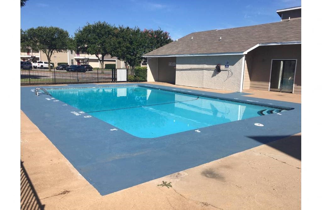 a large swimming pool in front of a house
