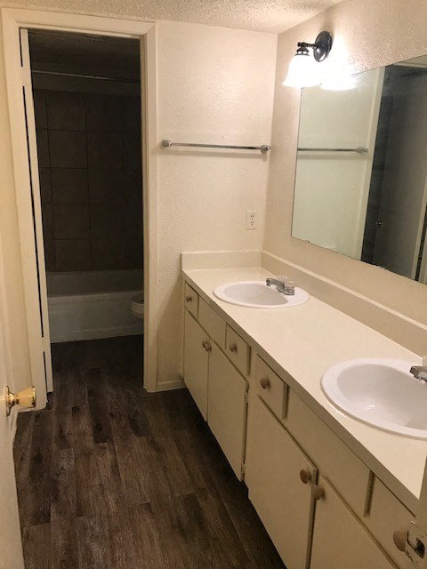 a bathroom with two sinks and a shower