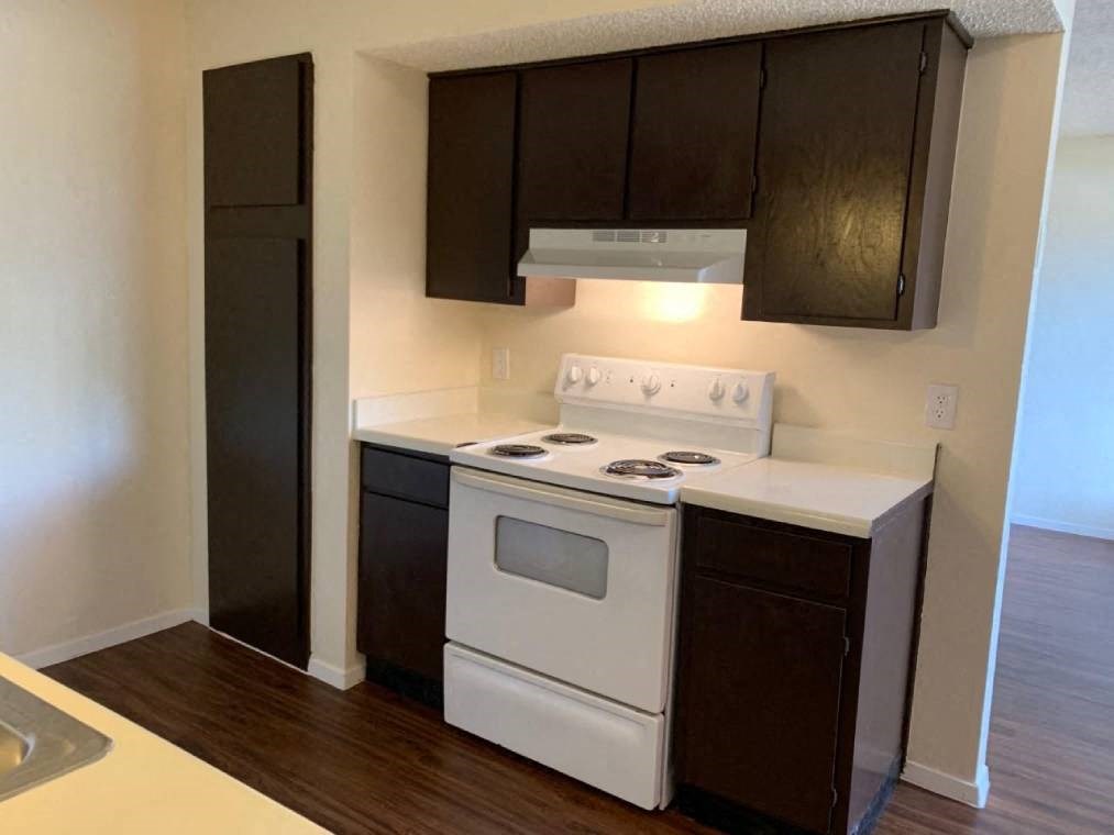 a white stove top oven sitting inside of a kitchen