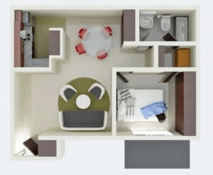 a bedroom with a bed and a desk in a room