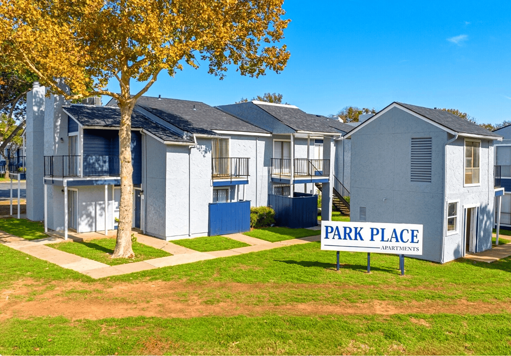 A row of houses with a sign that says Park Place Apartments.