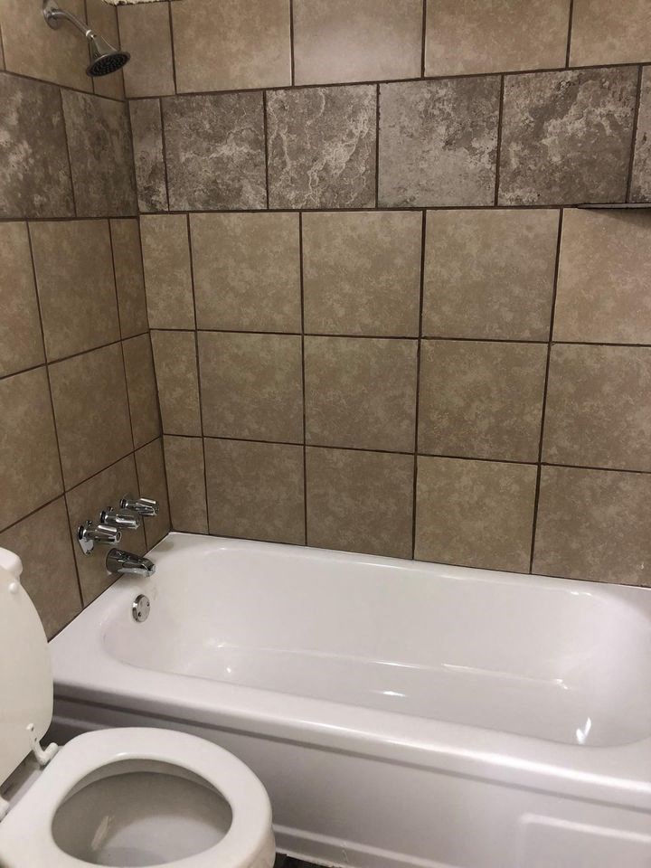 a bathroom with a toilet and a bathtub