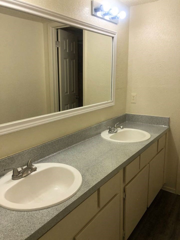 a bathroom with two sinks and a mirror