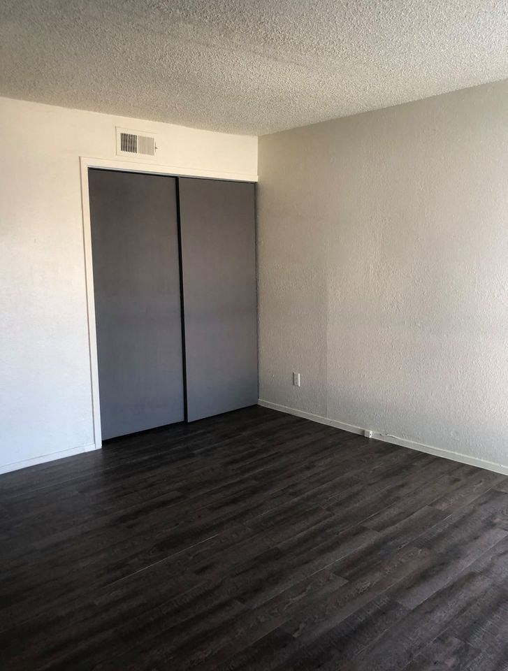 an empty room with a door to a closet