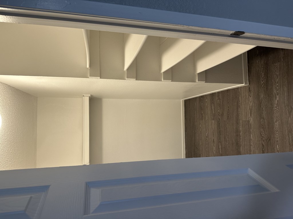 A white interior with a wooden panel on the right side.