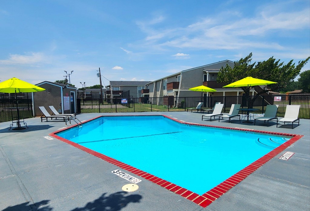 A large swimming pool with a red and white border.