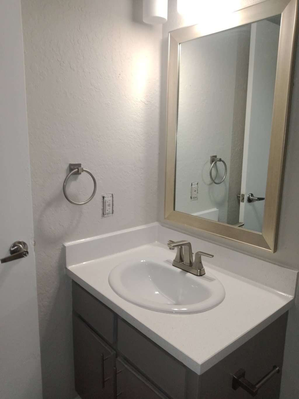 A bathroom with a sink and mirror.