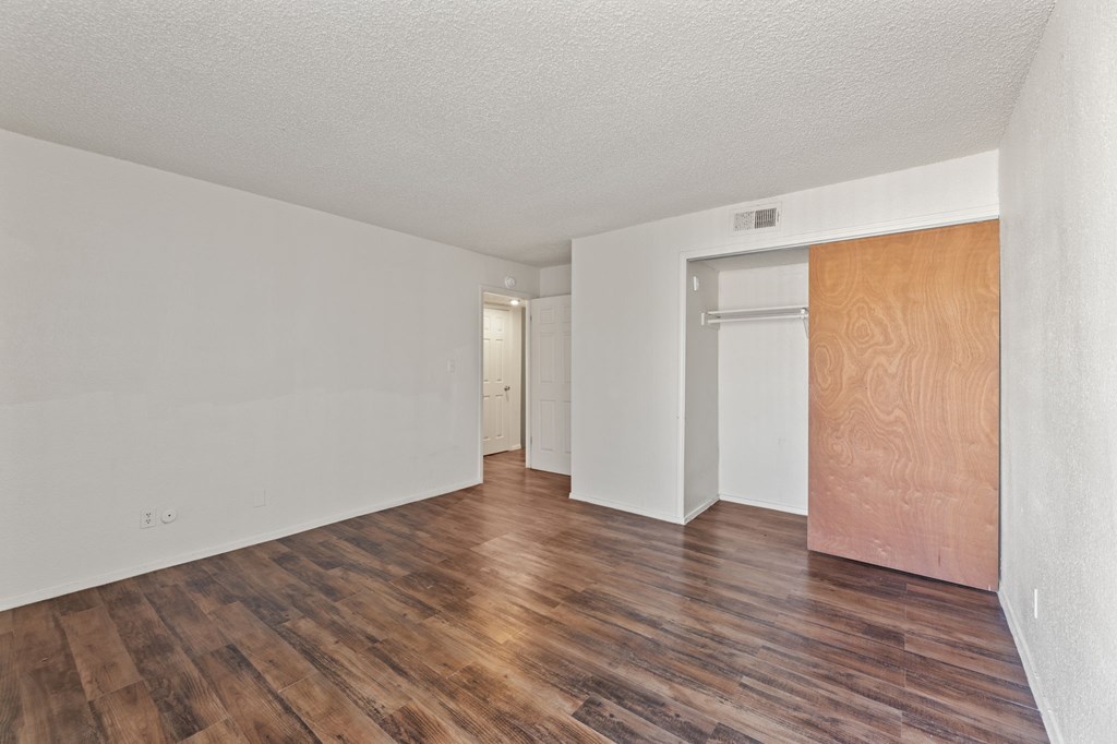 A room with wooden floors and white walls.